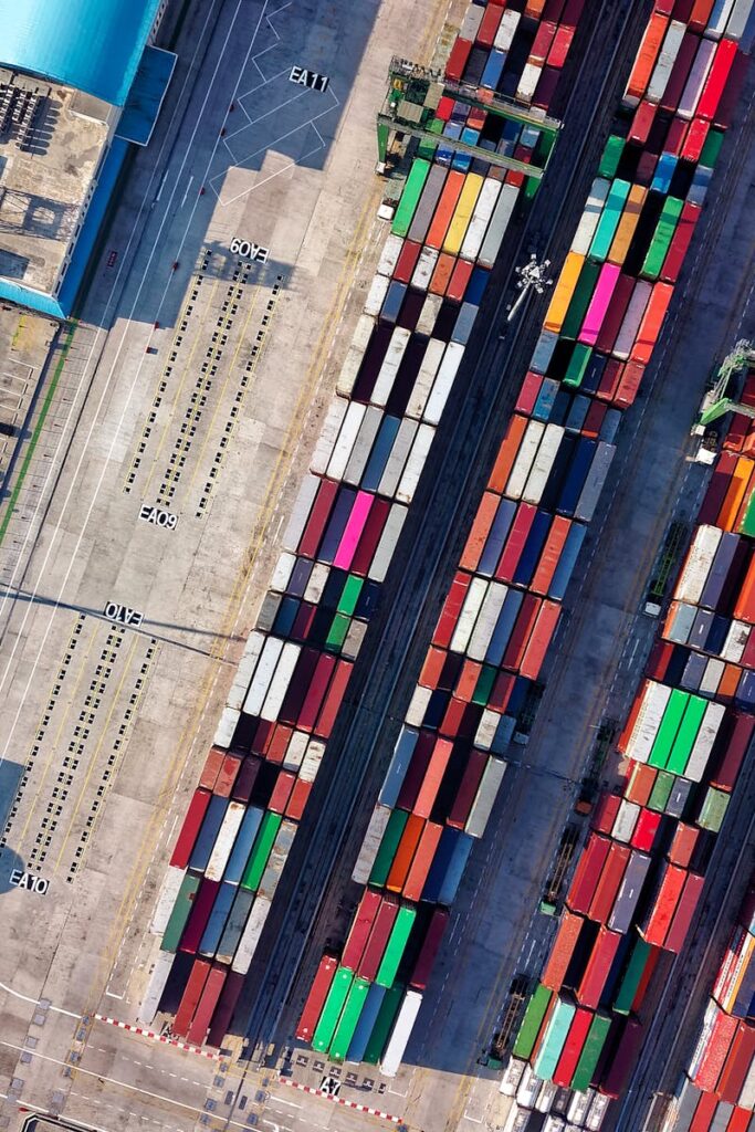 Top view of colorful shipping containers at a bustling port in Jakarta, Indonesia.