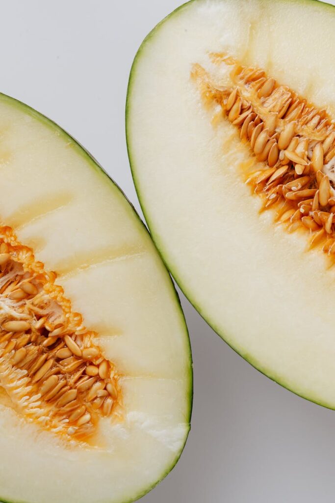 Close-up of freshly sliced cantaloupe melon showcasing seeds and texture.