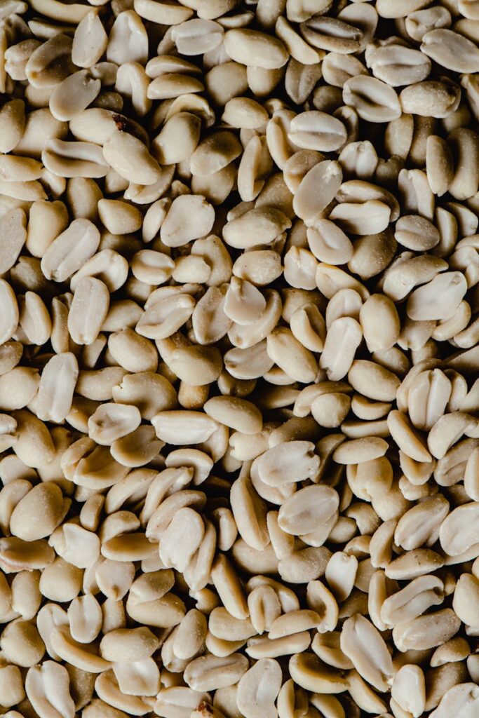 Close-up of shelled peanuts in bulk, showcasing texture for snack or food background.